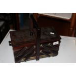 A stained wood four division concertina action sewing box with turned handle, 32 x 15 x 28 cm high.