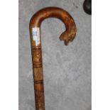 An African carved hardwood walking stick with lion head terminal. 88 cm long.