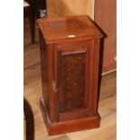 A late Victorian mahogany pot cupboard having a moulded square top over a single grained panel door