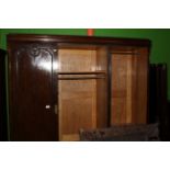 A 1930's oak four piece bedroom suite with bellflower swags and brass pendant handles - wardrobe,