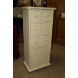 A modern cream painted multi drawer chest of drawers,