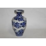 A Japanese blue and white decorated baluster vase with flared rim,