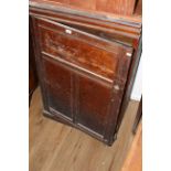A Victorian pitch pine cupboard with rectangular top over a triple panel door with incised frame,