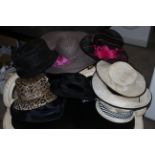 A Marks and Spencers ladies leopard print hat, decorated with sequins and ostrich feathers,