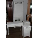 A modern white painted four piece bedroom suite, comprising a single wardrobe,