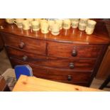 A late Georgian figured mahogany bow front chest of drawers with spiral turned quartered columns,