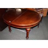 A Victorian mahogany extending dining table of moulded circular form,