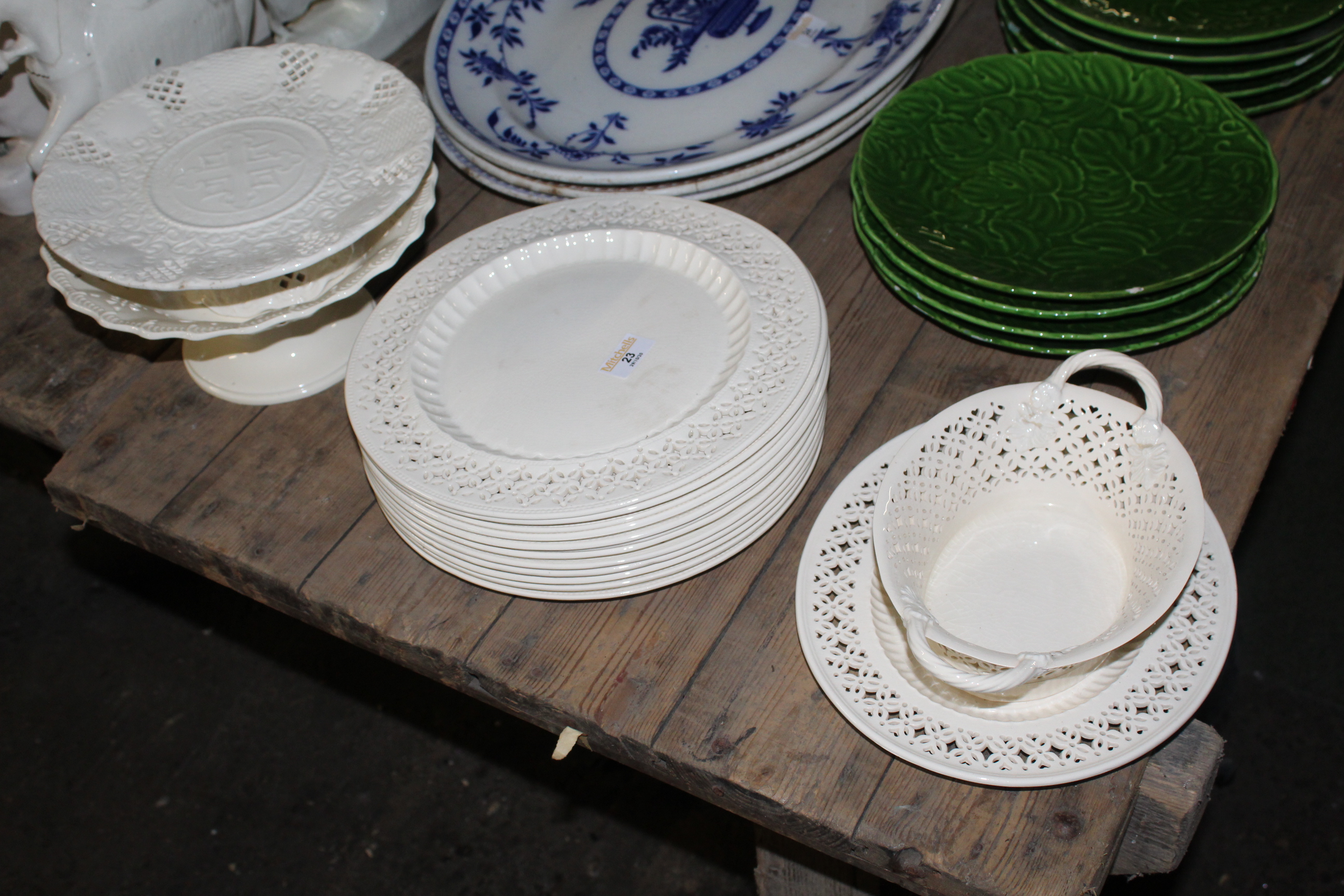 A quantity of reproduction Leeds cream ware pottery, comprising oval basket and stand,