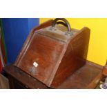 A late Victorian oak coal scuttle with copper handle,