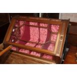 An Edwardian walnut corner cupboard of Georgian style with crushed pink velvet interior,