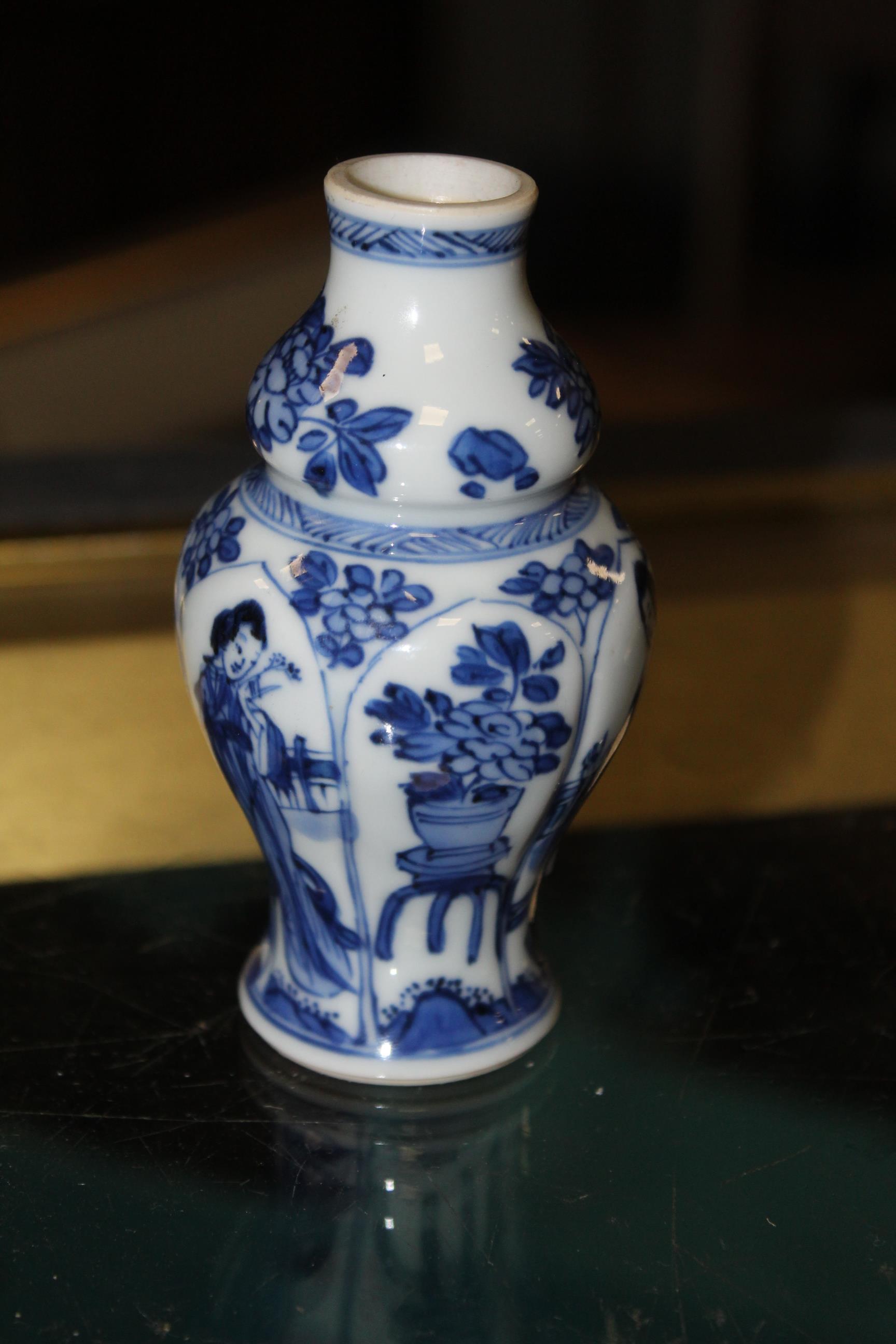 An early 20th century Chinese blue and white porcelain miniature baluster vase with lobbed sides,