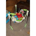 A Fisher Price Rain Forest Jumperoo babies bouncer seat and a Chicco babies walker.