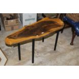 A modern Olive wood transverse section coffee table with simple tubular legs,