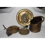 A brass coal scuttle, three brass trays and three brass fire irons.