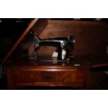 A 1920's electric singer sewing machine with figured walnut integral work table,