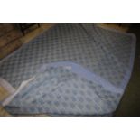 A pair of modern Elaine Springfield patchwork quilt decorated with gingham patches apposing blue