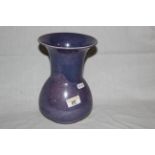 An early 20th century Ruskin pottery purple glazed bulbous vase with flared rim,