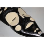 An African black and white painted face mask, 62 cm high.