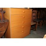 A teak effect laminate chest of drawers, 77 x 46 x 95 cm high.