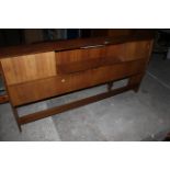 A mid century teak sideboard with central open niche, flanked by sliding doors,