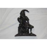 A black painted cast iron door porter modelled as a seated Mr Punch, 31 cm high.