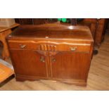 A 1930's oak sideboard with moulded rectangular top above two shaped drawers and cupboard doors