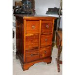 A modern mahogany six drawer chest with moulded top above an arrangement of six short drawers