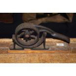 A late Victorian plumbers cast iron bending tool on wood mounts, 30 cm long x 16 cm high.