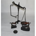 A Victorian cast box smoothing iron with turned wood handle, 19 cm high, a similar smaller ditto,
