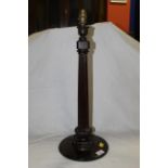 A mahogany reeded column table lamp with petal carved collars and a circular base, 50 cm to fitting.