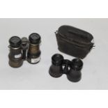 Two pairs of 19th century black lacquered gilt metal field glasses, one retaining its leather case.