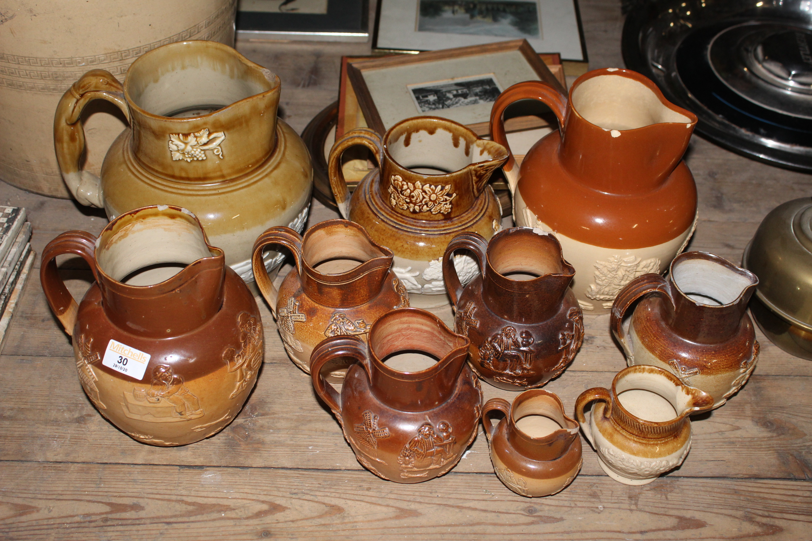 Ten 19th century two tone stoneware harvest jugs of various sizes including Doulton Lambeth.