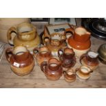 Ten 19th century two tone stoneware harvest jugs of various sizes including Doulton Lambeth.