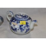 A Chinese export globular teapot decorated with flowers and stylised borders with unglazed base