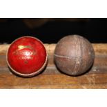 A Vintage stitched leather cricket ball and a Slazenger crown stitched red leather cricket ball.