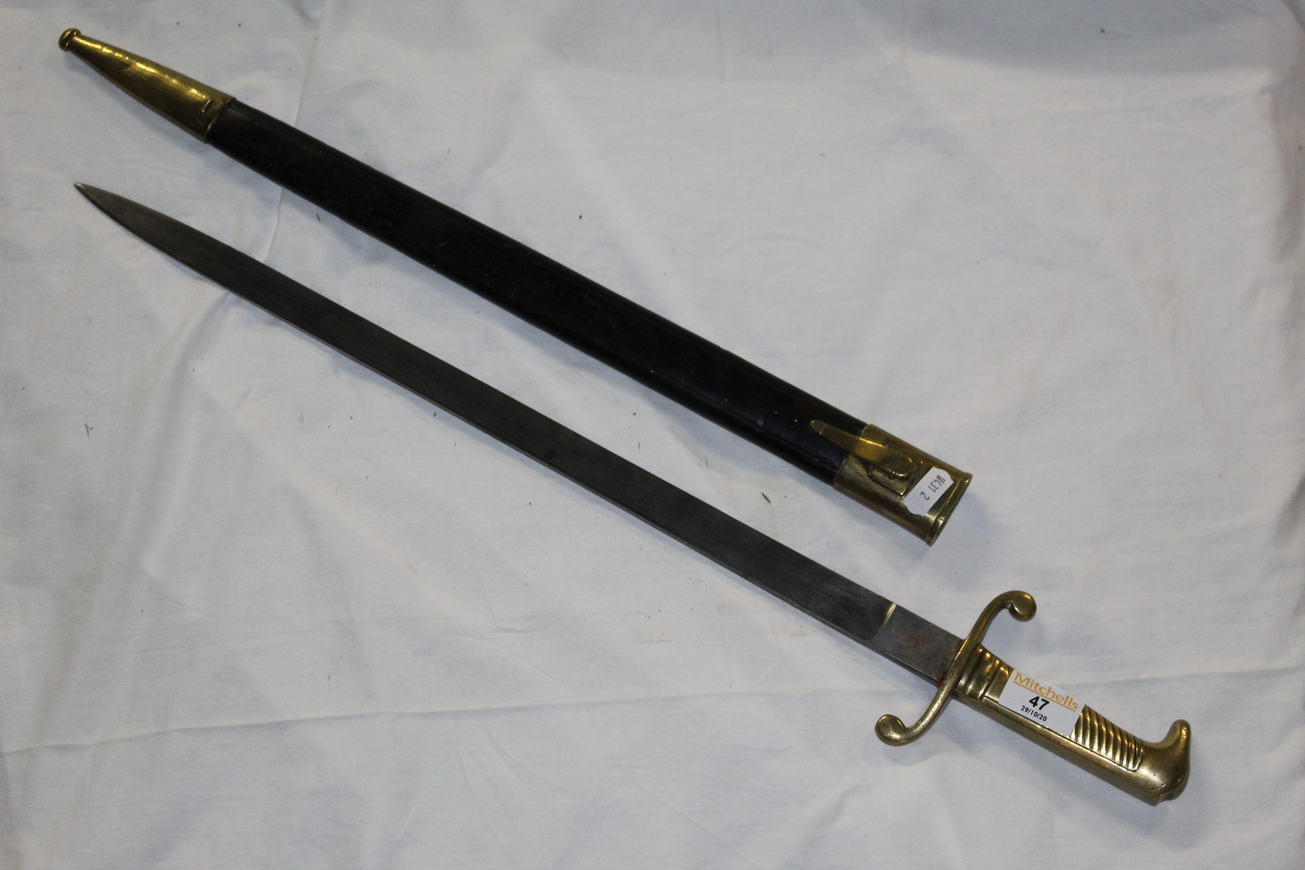 An early 19th century French artillery short sword with brass hilt and etched blade,