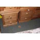 A pair of modern pine bedside chests with moulded rectangular tops above 2 drawers and raised on