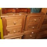 A pair of modern pine bedside chests having a moulded rectangular top above 2 moulded panelled