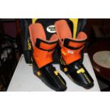 A pair of Salomon HPC SX92 ski boots and snow and rock bag.