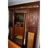 An Edwardian mahogany and walnut and mirror door wardrobe,