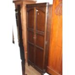 A 20th century oak double door wardrobe in the manner of Old Charm,