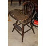 A child's stained beech wood high chair, with turned legs, 96 cm high.