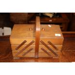 A beech wood folding sewing box with curved handle, 33 x 17 x 28 cm high.