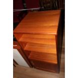 A 1970's teak music cabinet with three divisions over a panelled base door, 101 cm x 48 cm x 47 cm,