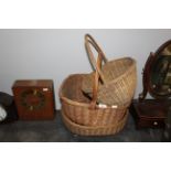 A group of three vintage woven wicker baskets, two with handles.