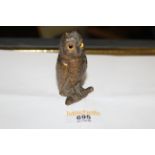 A late 19th/20th century lacquered bronze owl form ink well, the lifting head with glass eyes,