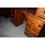 A pine kneehole dressing table fitted with 8 drawers, 140 cm wide x 45 cm deep, 75 cm high.