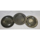 A group of three 19th century pewter chargers, 35 cm in diameter.