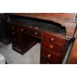 A Victorian panelled mahogany kneehole pedestal desk, the top inset with green leather,