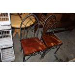 Pair of modern metal framed and hardwood seated chairs of ecclesiastical design,